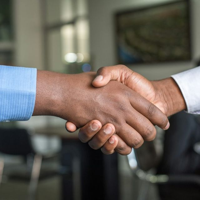 Advisor and client shaking hands after agreeing a financial plan