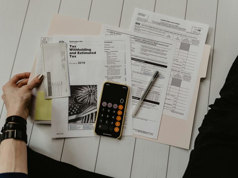 Tax documents and calculator laid out for planning
